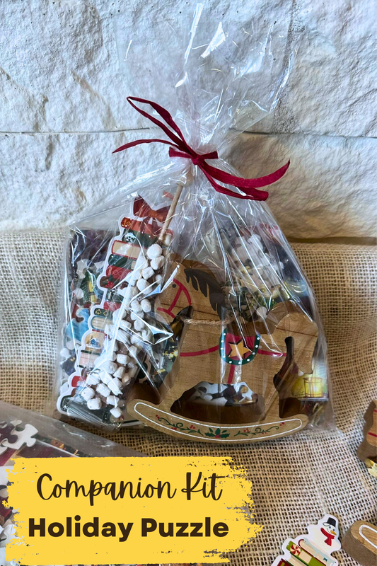 Cellophane bag with rocking horse decoration, cocoa stir stick, holiday bookmark, and holiday puzzle inside. 
