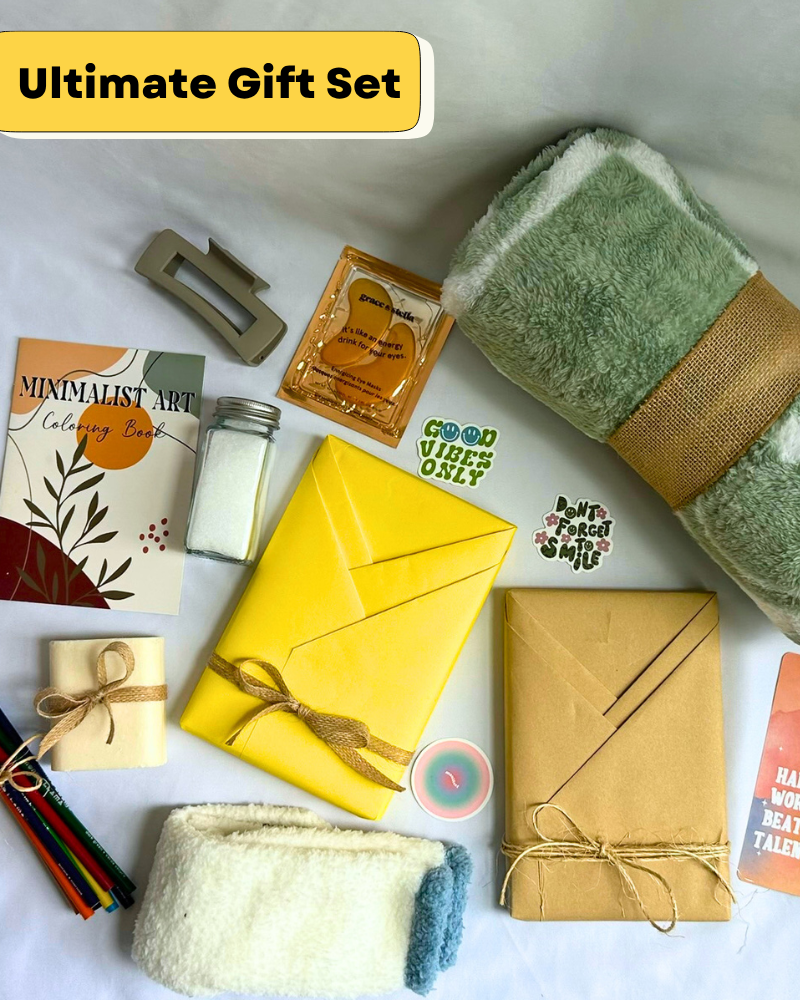 Gift Box with fleece blanket, cozy socks, bar soap, bath salts, coloring book, colored pencils, hair clip, featuring a blind date with a book with bookish items. 