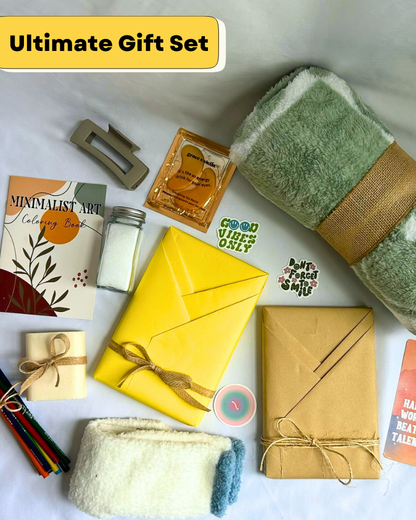 Gift Box with fleece blanket, cozy socks, bar soap, bath salts, coloring book, colored pencils, hair clip, featuring a blind date with a book with bookish items. 