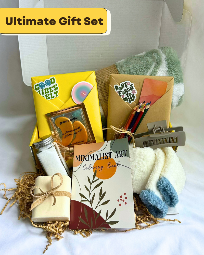 Gift Box with fleece blanket, cozy socks, bar soap, bath salts, coloring book, colored pencils, hair clip, featuring a blind date with a book with bookish items. 