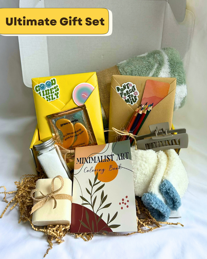 Gift Box with fleece blanket, cozy socks, bar soap, bath salts, coloring book, colored pencils, hair clip, featuring a blind date with a book with bookish items. 